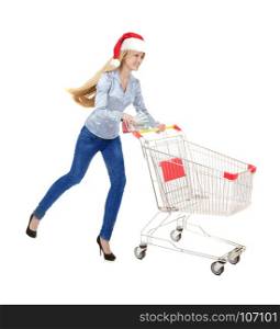 Young Woman Running with Empty Shopping Trolley for Christmas Purchase in Santa Hat and a Big Bundle of Dollars isolated on White Background