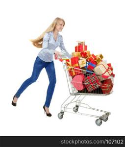 Young Woman Running with Full Shopping Trolley of Red, Gold and Yellow Christmas Gifts and a Big Bundle of Dollars isolated on White Background