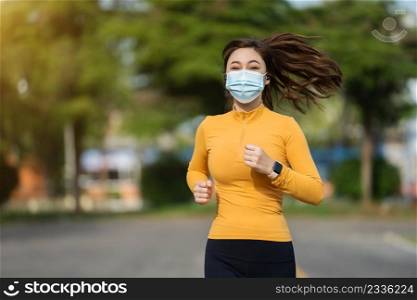 young woman running with medical mask to protect Coronavirus Covid-19  pandemic