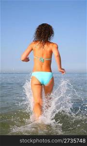 Young woman runs on water from back