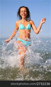 Young woman runs on water in sea