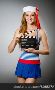 Young woman sailor with movie board