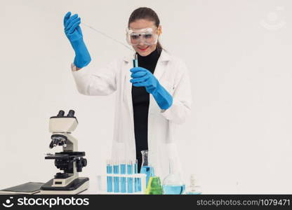 Young woman scientist working in chemical laboratory and examining biochemistry lab sample. Science technology medicine research and development study concept.