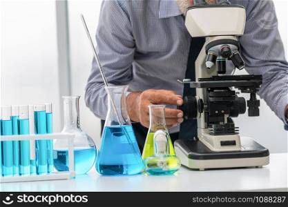 Young woman scientist working in chemical laboratory and examining biochemistry lab sample. Science technology medicine research and development study concept.