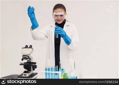 Young woman scientist working in chemical laboratory and examining biochemistry lab sample. Science technology medicine research and development study concept.