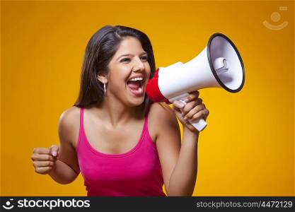 Young woman screaming into a megaphone