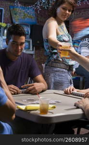 Young woman serving beer at local bar