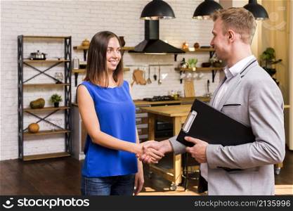 young woman shaking hand with businessman