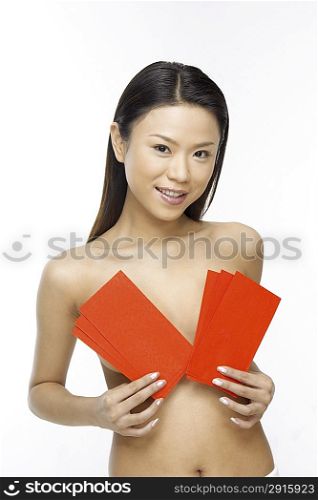 Young woman sheltering herself by cards