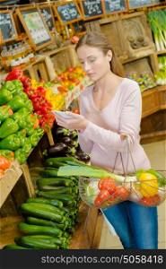 Young woman shopping at the greengrocer&rsquo;s