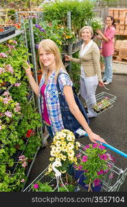 Young woman shopping flowers at market garden centre