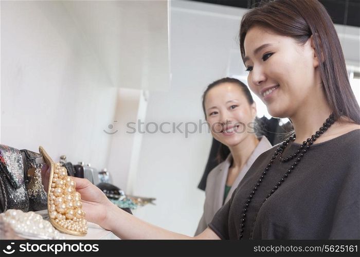 Young woman shopping for accessories at store