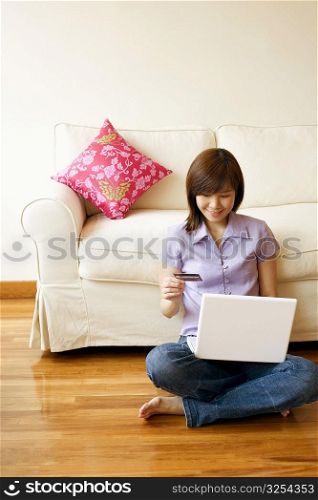 Young woman shopping online with a credit card