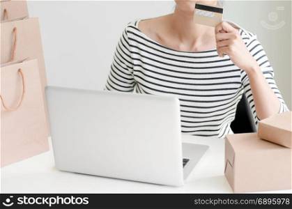 Young Woman Shopping Online With Debit / Credit Card, payment and marketing concept