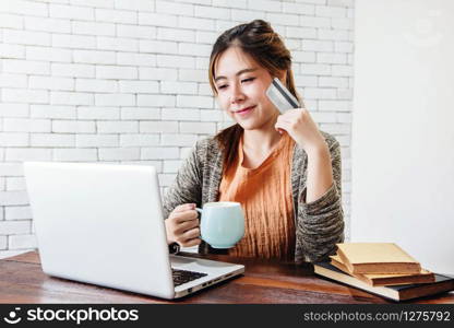 Young Woman Shopping or Making Payment by Credit Card and Laptop at Home, Happy Female Buying Products via Online
