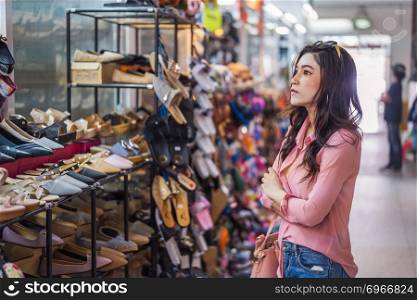 young woman shopping shoes in a shop