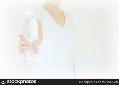 young woman show bottle of water . isolated
