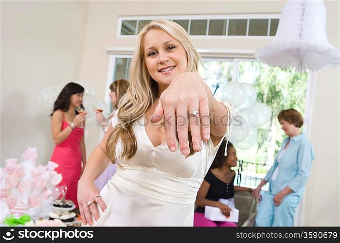 Young woman showing engagement ring