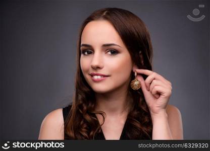 Young woman showing her new earrings
