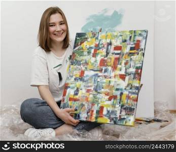 young woman showing her painting 2
