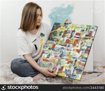young woman showing her painting