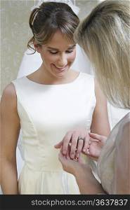 Young woman showing middle-aged woman ring on finger