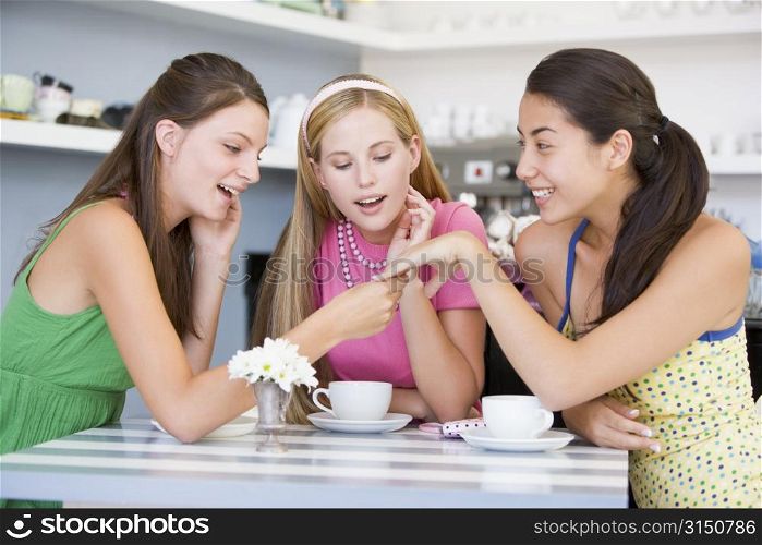 Young woman showing off engagement ring to friends