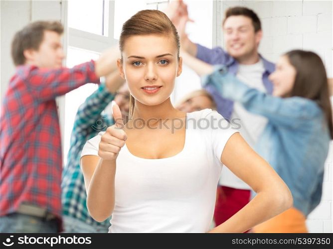 young woman showing thumbs up at school