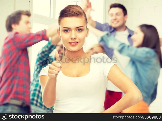young woman showing thumbs up at school