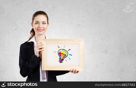 Young woman showing wooden frame with drawn bulb