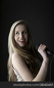 Young woman singing in studio