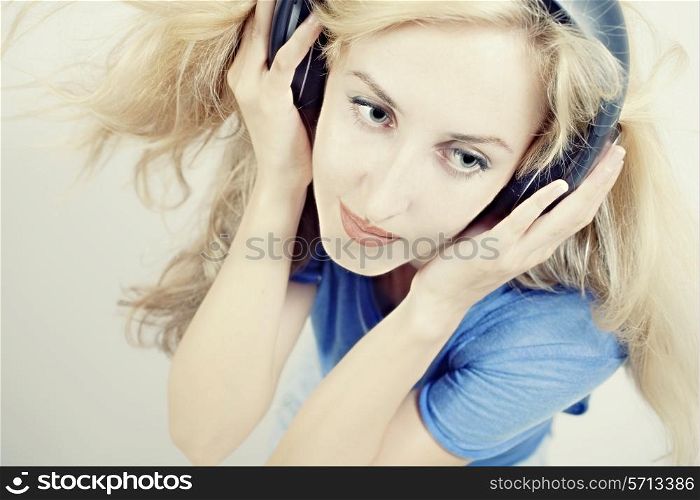 young woman singing with headphones isolated on light background