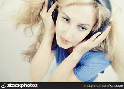 young woman singing with headphones isolated on light background