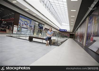 Young woman sits in new Voronezh shopping centre