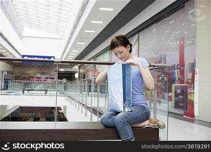 Young woman sits in new Voronezh shopping centre