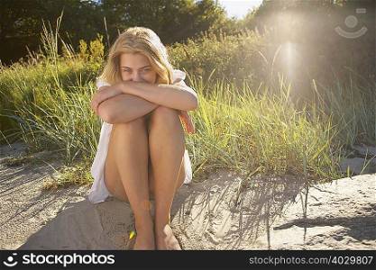 Young Woman Sitting at edge of beach