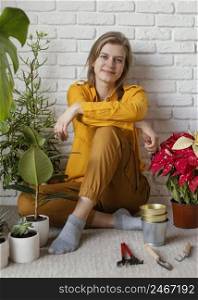 young woman sitting her home garden floor