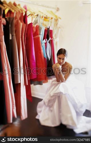 Young woman sitting in a store and looking serious