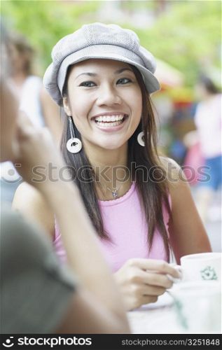 Young woman sitting in an outdoor restaurant