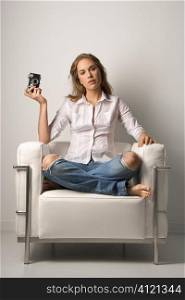Young Woman Sitting in Chair with Camera