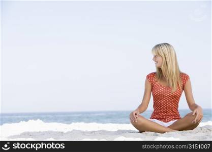 Young woman sitting on a beach