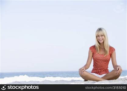 Young woman sitting on a beach