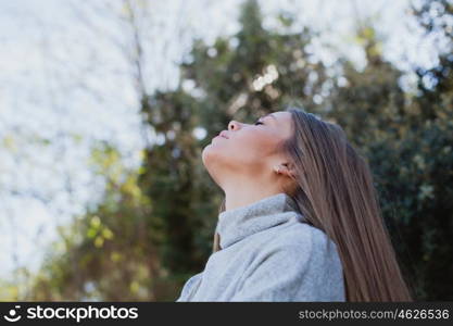 Young woman sitting on a big stone in a relaxed day