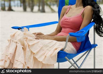 Young woman sitting on a folding chair
