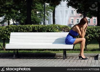 young woman sitting on a park bench