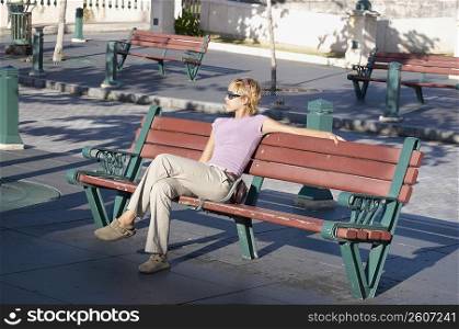 Young woman sitting on park bench