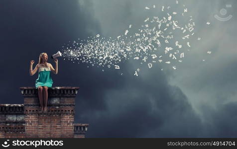 Young woman sitting on roof and screaming in megaphone. Can anybody hear me