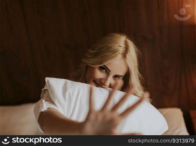 Young woman sitting on the bed in the room