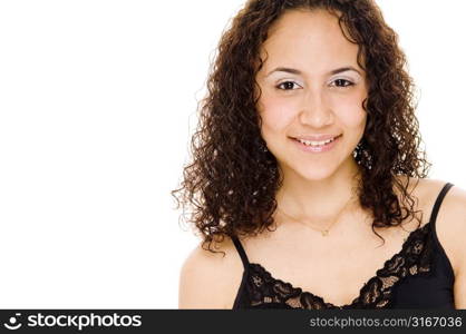 Young woman sitting on the bed with a duvet over her shoulders