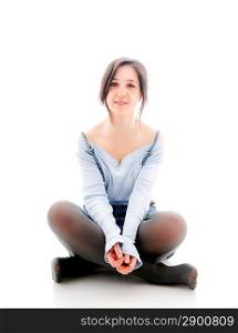 Young woman sitting on the floor. Isolated over white.